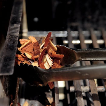 Placing woodchips in a smoker