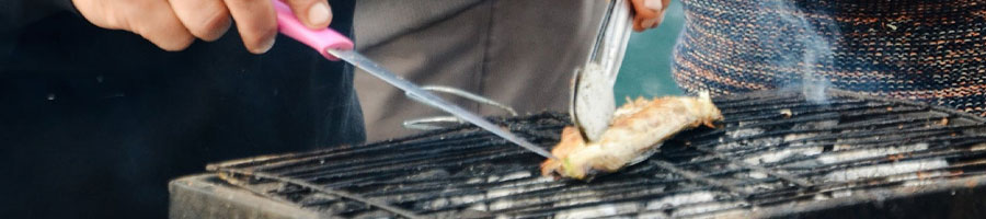 Man checking meat on a grill