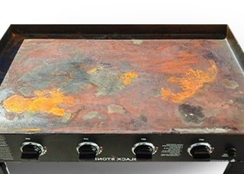 A griddle top full of rust