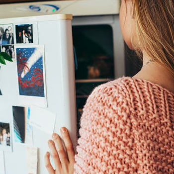 Woman opening a refrigerator