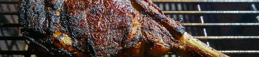 Tomahawk steak on a grill close up image