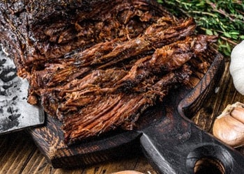 Sliced brisket on a chopping board