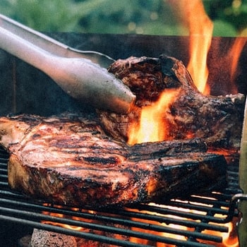 A person doing a hot smoking method for his meats