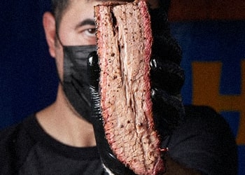 A guy holding a brisket