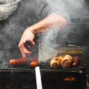 A guy doing a warm smoking for his meats