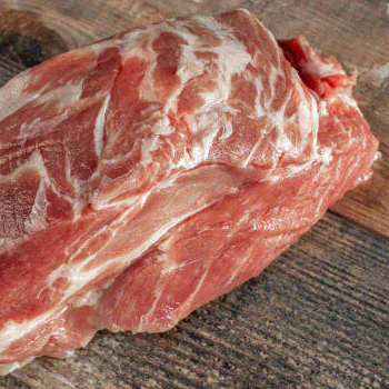 Pork shoulder on a wooden surface