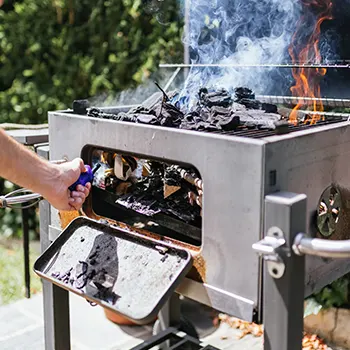 Man setting up an electric grill outdoors