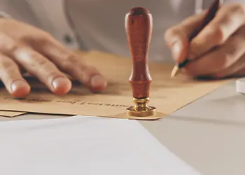 Hand view of a person writing on a paper
