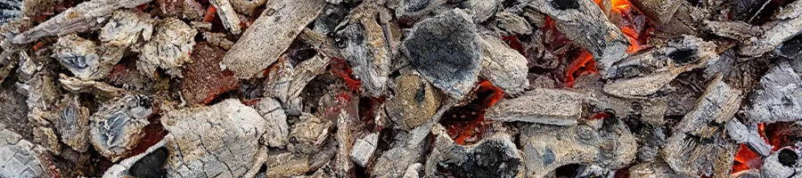 Used charcoals burning in a grill