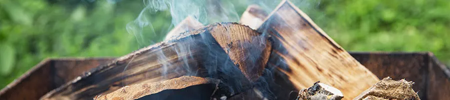 Burnt wood with smoke settling down