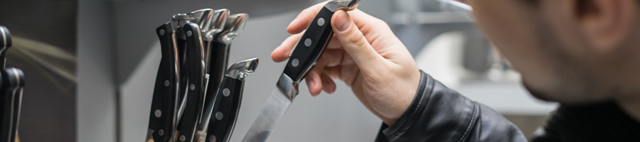 A man choosing a knife to buy