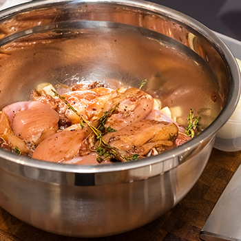 Raw marinated chicken in a bowl