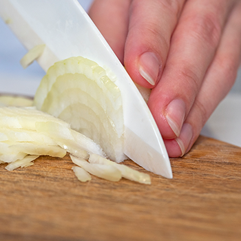 A person slicing onions