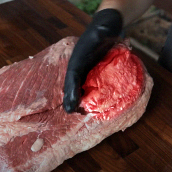 Trimming the fat cap from the brisket meat