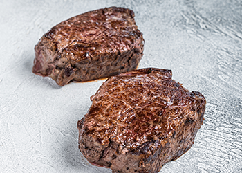 Grilled fillet mignon on plain background