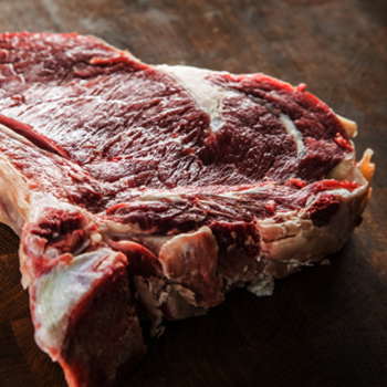 Rib eye steak with bone butcher board