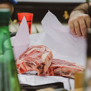 Both hands wrapping and packing meat