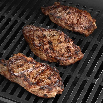 Three meat on top of cooking grate