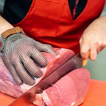 A butcher slicing off a meat