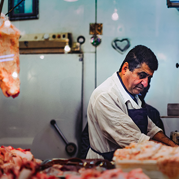 Butcher looking at the meat