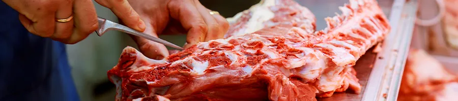 A butcher cutting meats