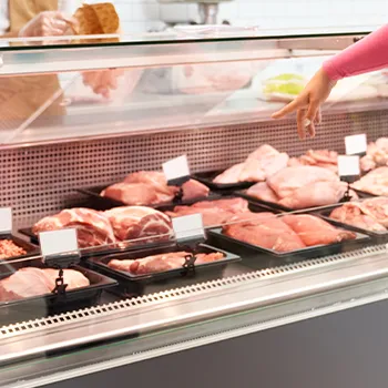 A woman pointing on a meat she wanted to buy