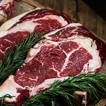 Raw ribeye steak on table