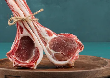 Lamb meat tied together on wooden board