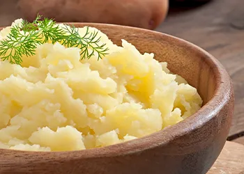 Mashed potato on a small wooden bowl