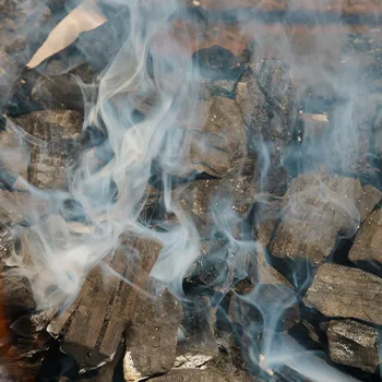 Close up image of a smoking charcoal