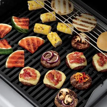 Different foods on top of cooking grate