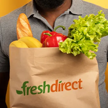 Man holding vegetables and groceries