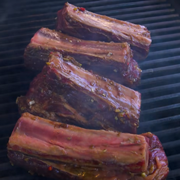 Close up image of beef ribs cut on grill