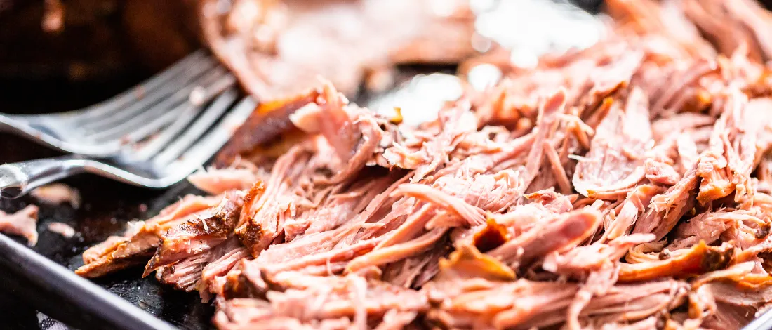 Pulled pork with fork close up image