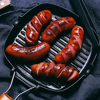 Freshly cooked hotdogs on a grill pan