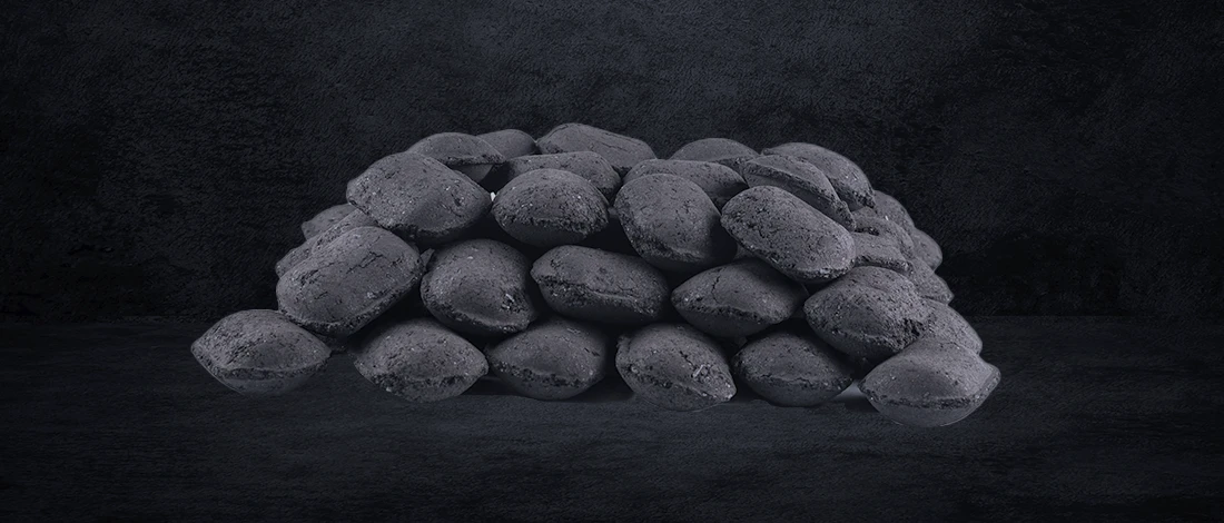 Charcoal briquettes on dark textured background