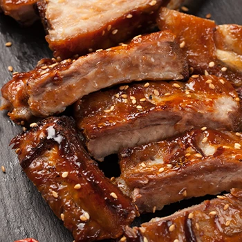 Close up image of a cooked and sliced baby back ribs