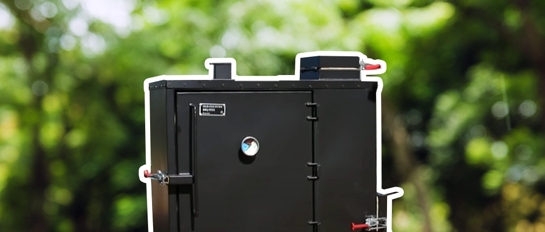Gravity fed smoker with white outer stroke blurred outdoor background