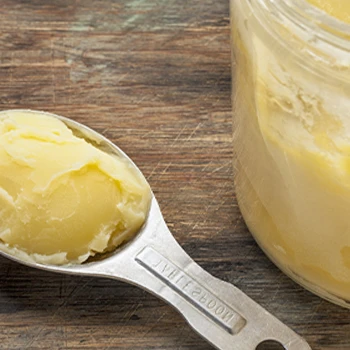 A spoon full of Ghee close up image