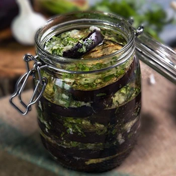 Eggplant slices inside a brine jar