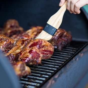 Brushing the meat inside the smoker