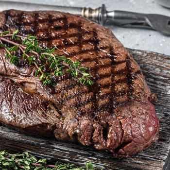 Fresh steak resting on cutting board