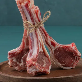 lamb chops on a circular wooden platform