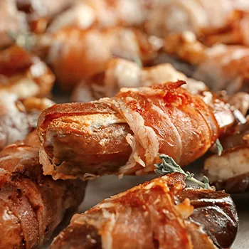 Close up image of a bacon wrapped dates