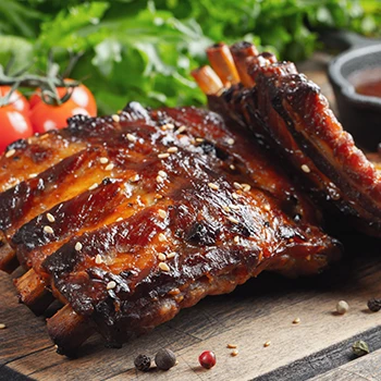 A close up image of back ribs with vegetables