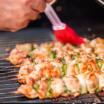 Basting chicken bbq on grill