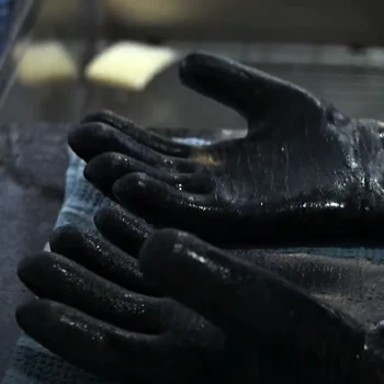 A wet barbeque gloves on top of kitchen sink