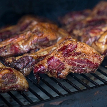 Meat inside a smoker grill