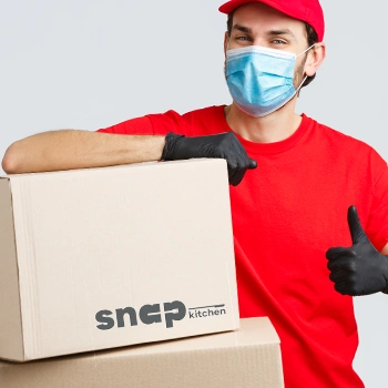 Delivery guy handling boxes and giving a thumbs up