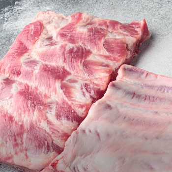 Raw spare ribs on stone surface